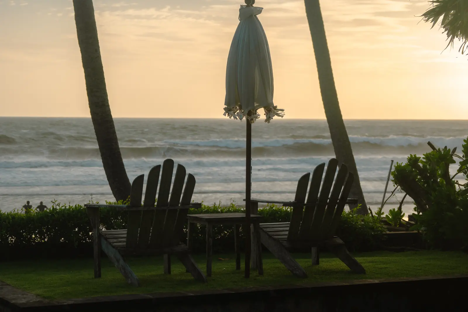 Garden chairs facing the sea in the evening light at Villa Lux Bali on Pasut Beach