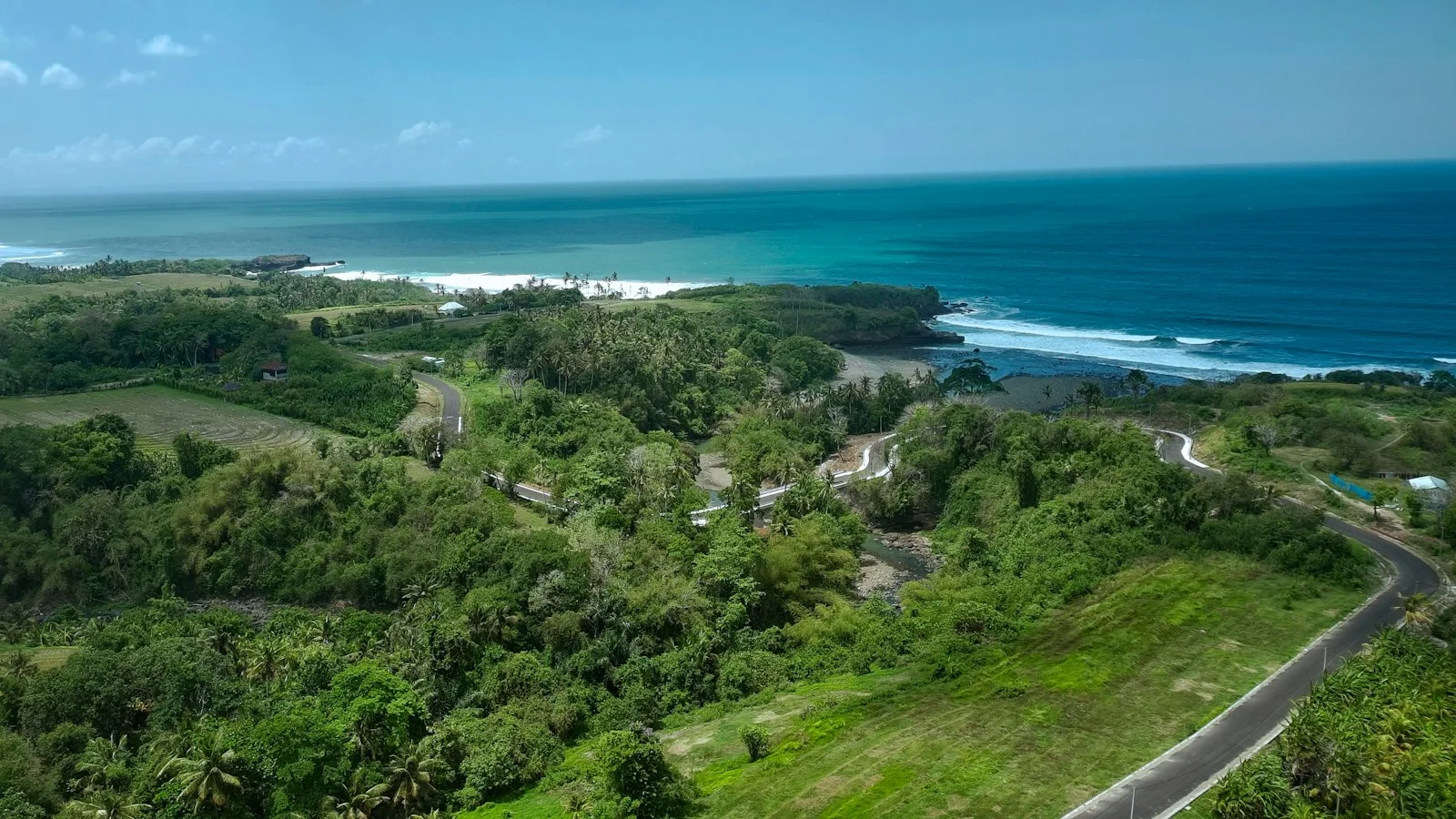 Aerial view of the coastline and tropical greenery at Soka Beach, Bali