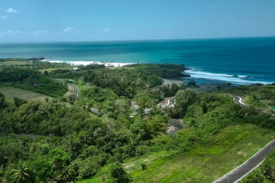 Aerial view of the coastline and tropical greenery at Soka Beach, Bali