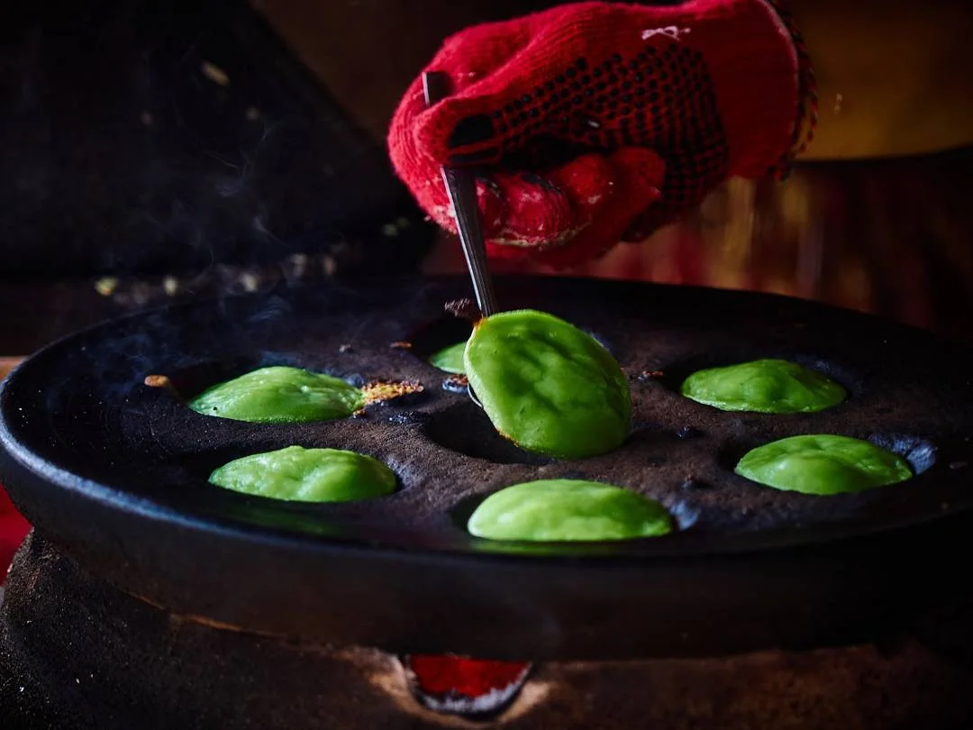 Green jaje laklak cooking in a traditional mould in Denpasar, Bali